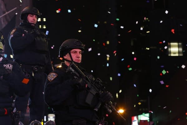 Police officers watch in Times Square