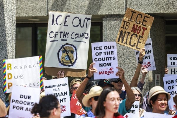 Immigrant rights advocates hold a press conference outside the Whipple Federal Building