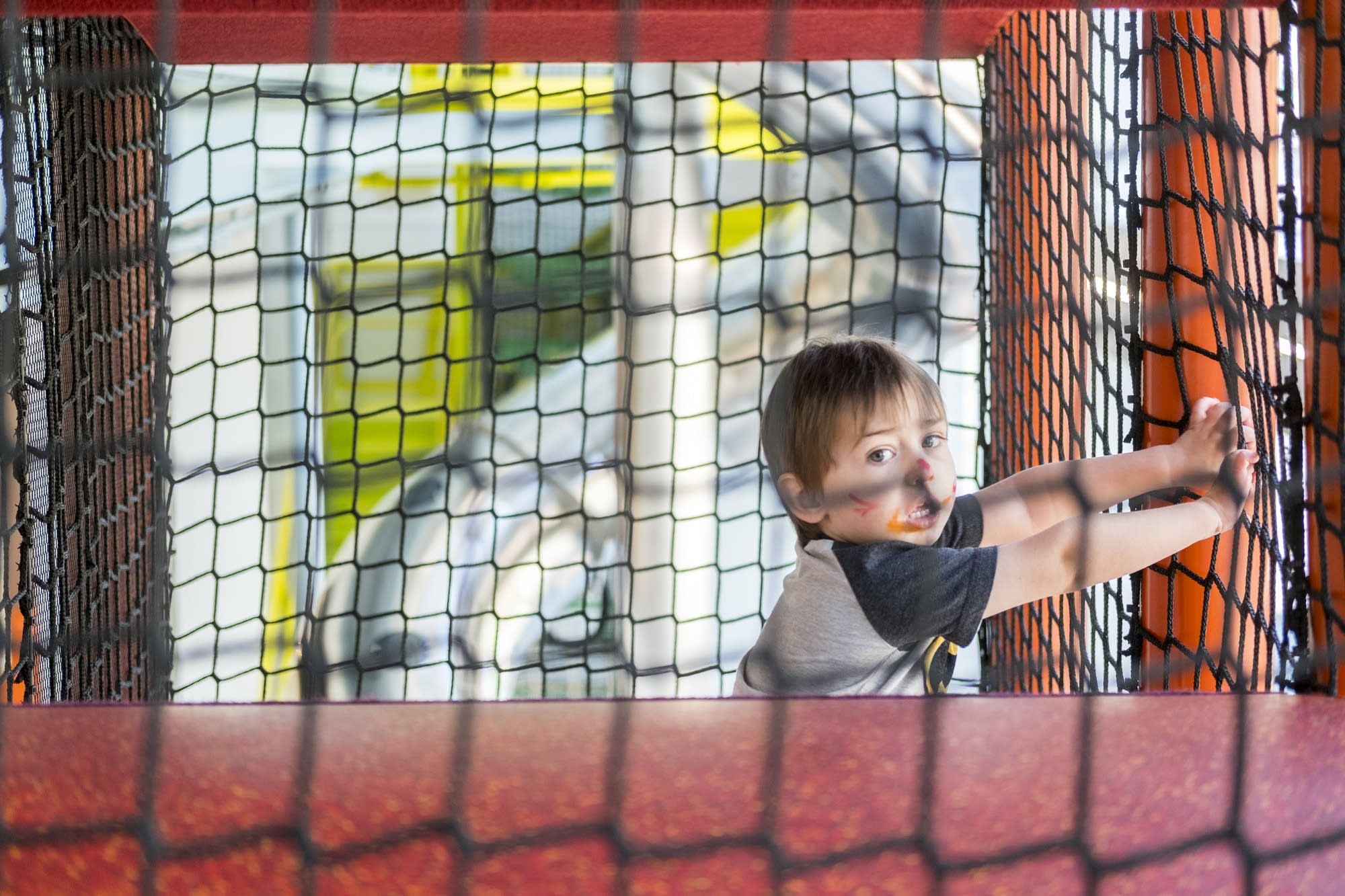 Aiden Tjelmeland climbs inside of the Scramble.