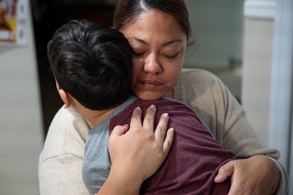 woman hugs child
