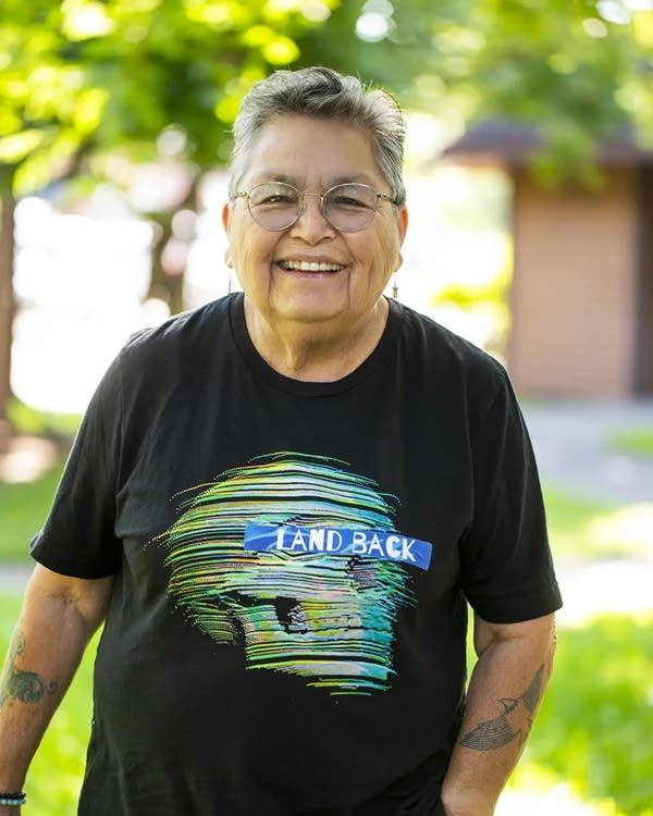 A person in a black t shirt smiles