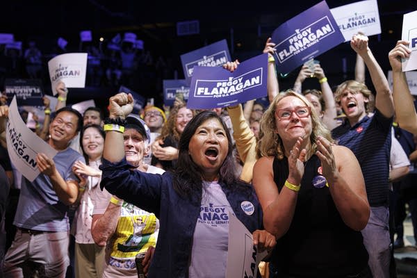 A crowd of supporters cheers for Peggy Flanagan.