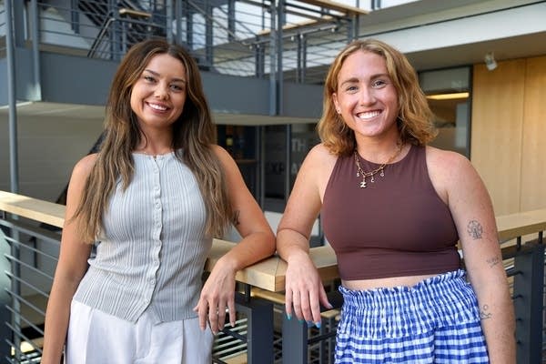 two women pose for a portrait