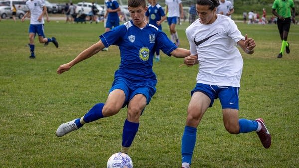 A player kicks a soccer ball