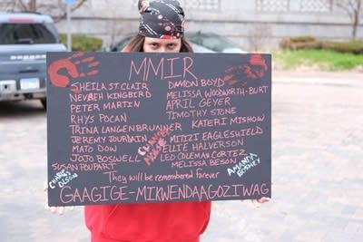 person holding an MMIR memorial sign