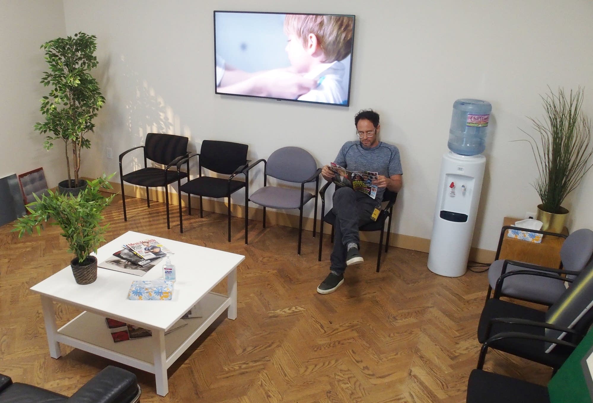 Omer Fast sits in the doctor's waiting room, the entrance to his show.