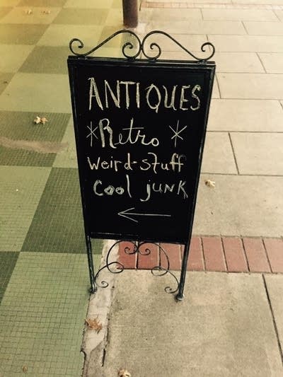 A sign outside of Galaxy Office Furniture in North Little Rock, Arkansas that reads, "Antiques, Retro, Cool Junk"