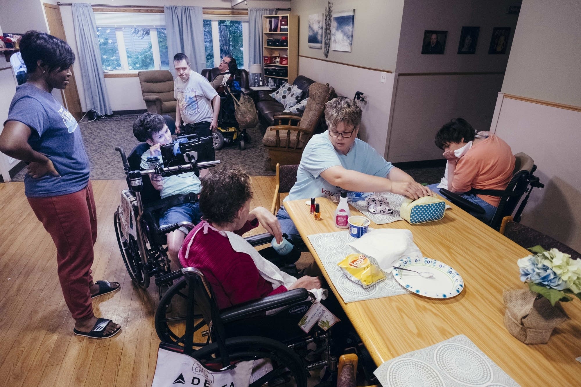 Two caregivers watch over five residents.