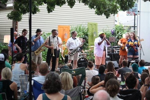 A band performing in a backyard concert venue