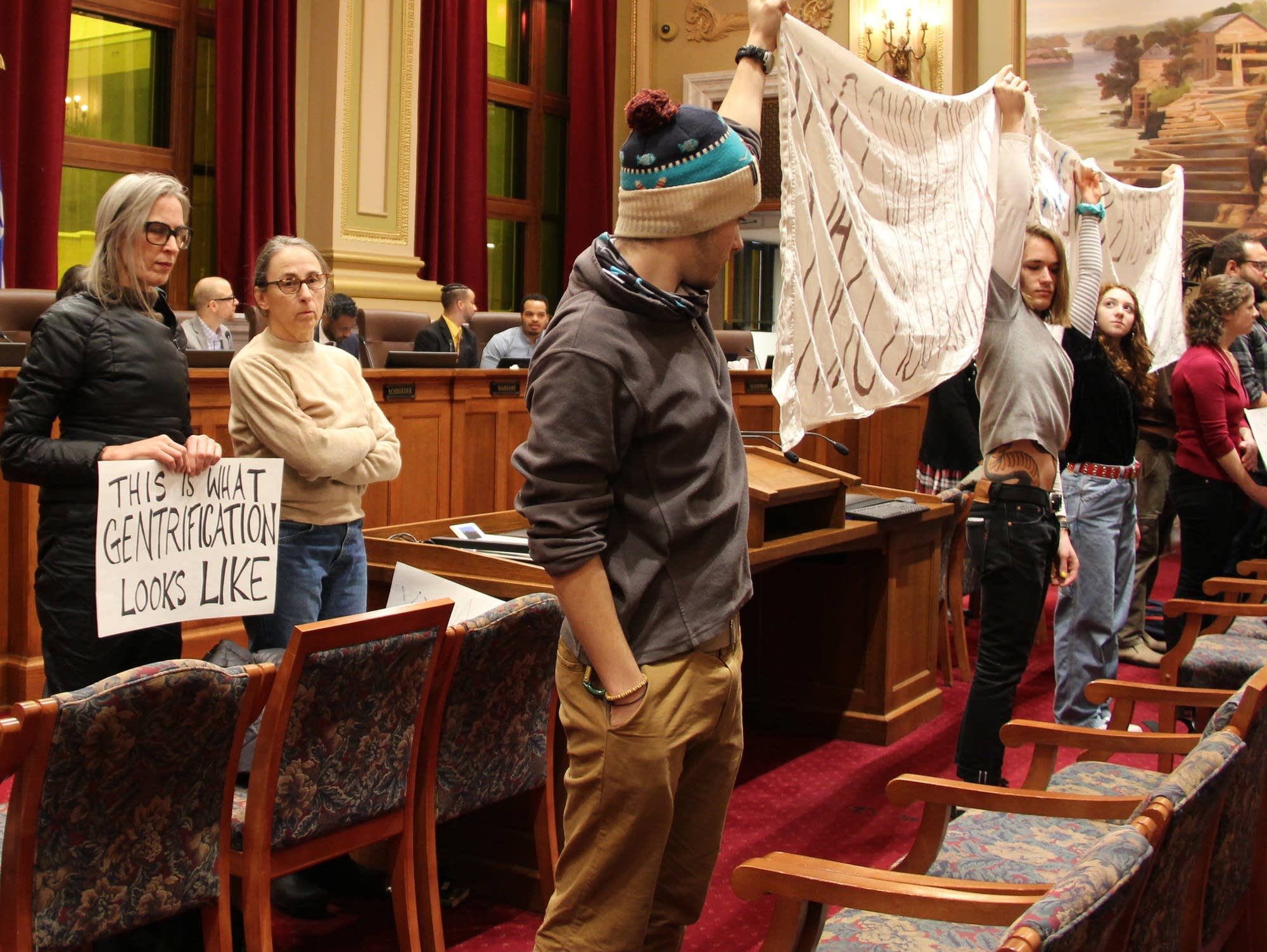 Community members and students protest the concept plan.