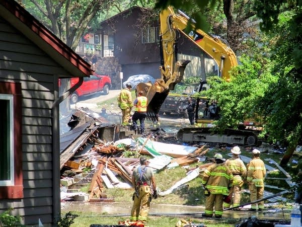 An excavator helps fire and rescue crews