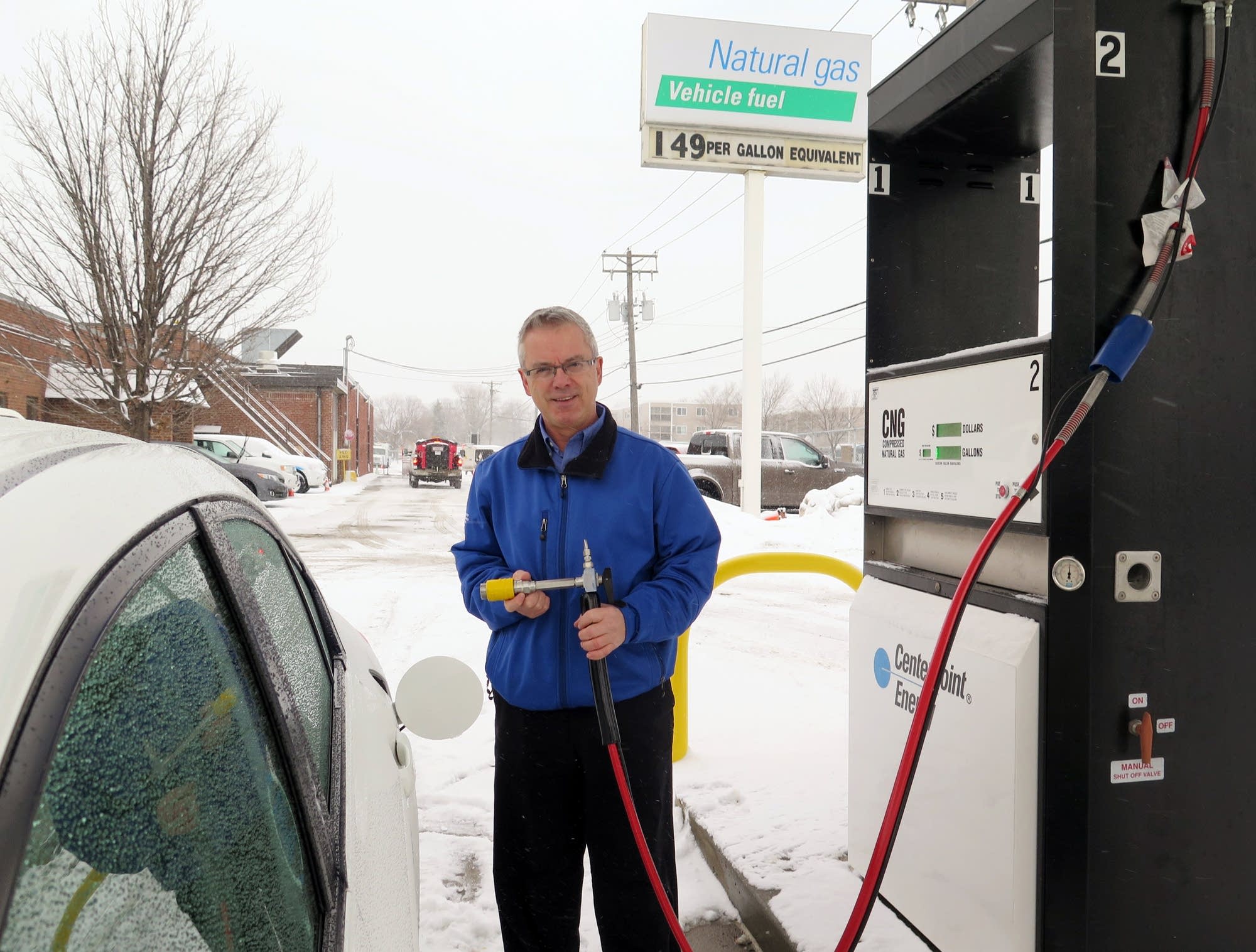 Mark Spanton displays the nozzle for compressed natural gas fuel.