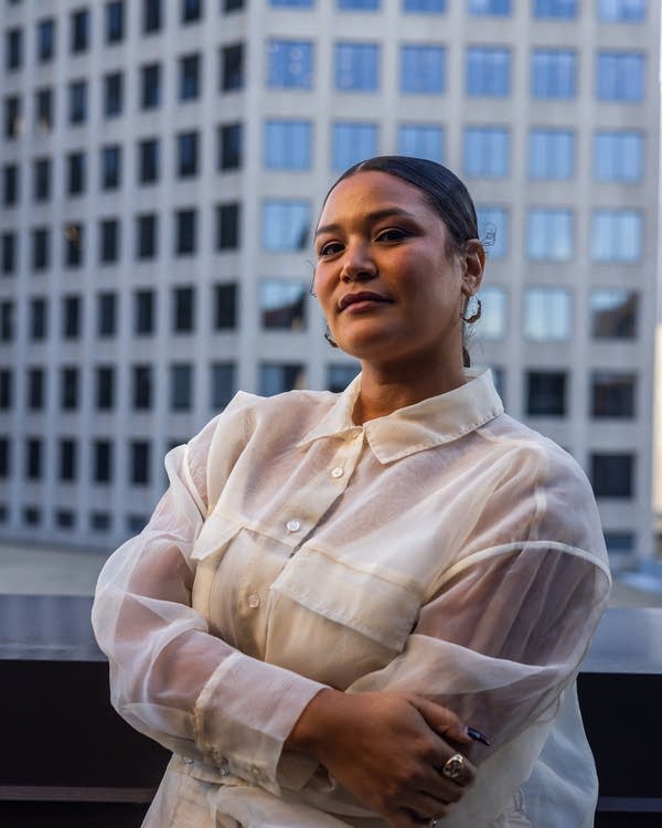 Lady Midnight crosses arms over white shirt