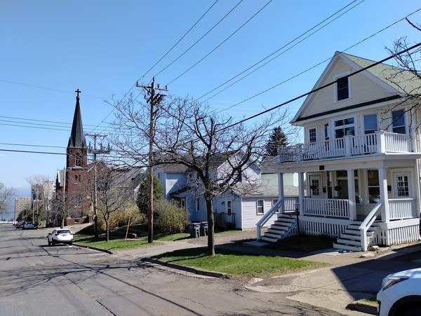 A white two-story house with upper and lower front porches.
