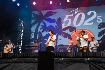 A band performing on a large outdoor stage