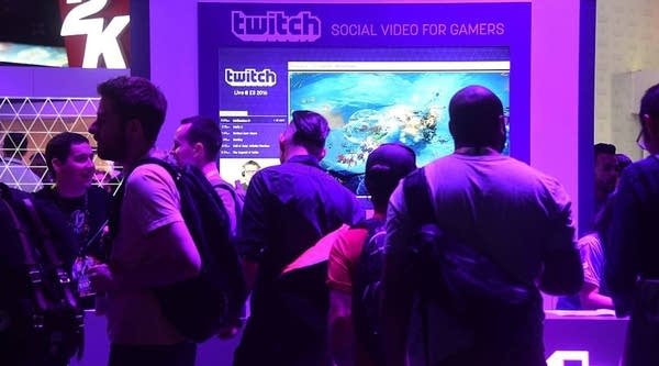 People wait in line at booth for Twitch, the official Livestream Partner of E3 during the 2016 Electronic Entertainment Expo (E3) annual video game conference and show on June 14, 2016 in Los Angeles, California.