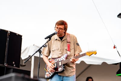 Gash performing on an outdoor stage.