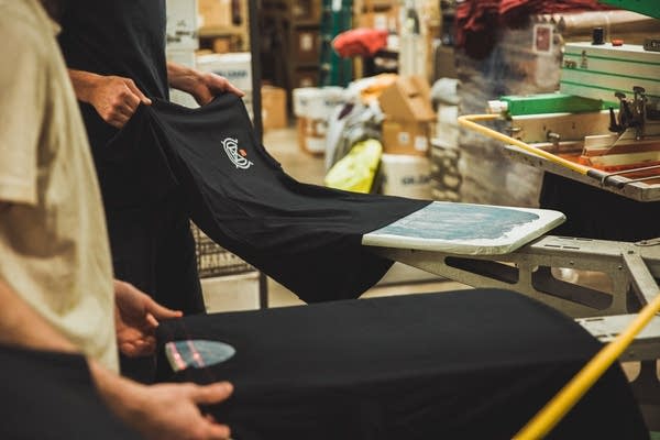 Pulling an Eaux Claires shirt off the screen printing press