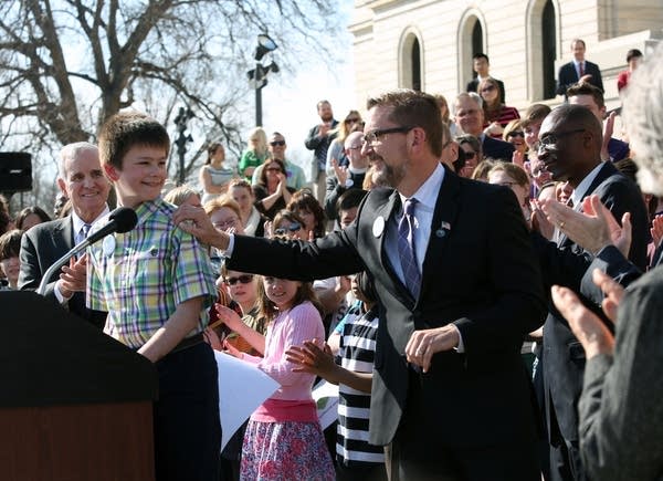 Jake Ross celebrates the signing of the law.