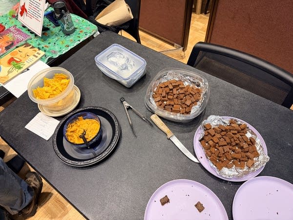 Brownies hummus and chips on a table