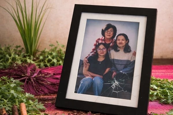 A photo frame shows a family as part of a promotional image for a theatrical play.