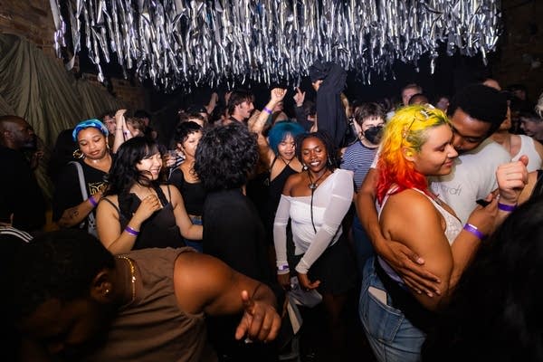 a crowd dancing to a dj set