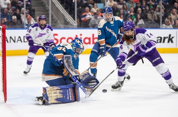 A Minnesota Frost player makes a shot on goal against the Vancouver Goldeneyes.