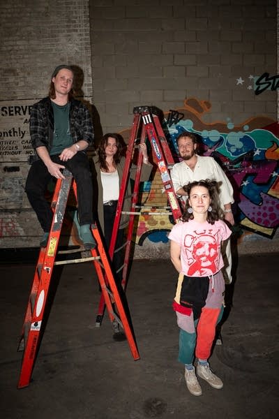 the band kiernan posing for a photo with 2 ladders