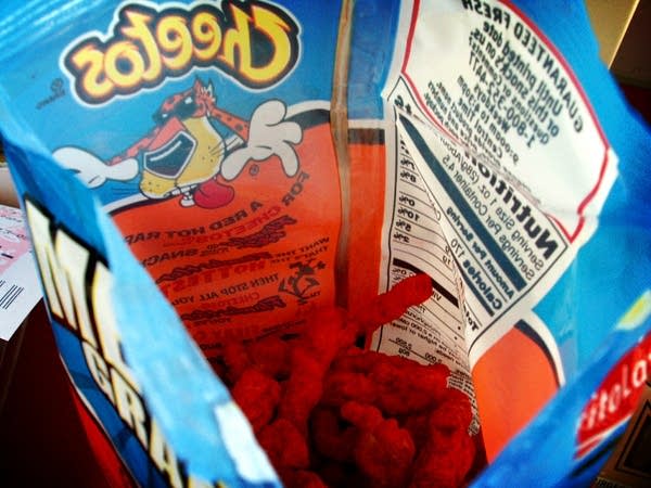 Photo looking down into an open bag od Hot Cheetos