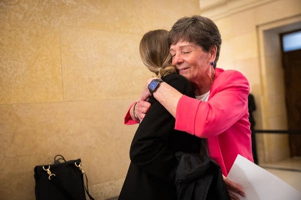 Two women embrace