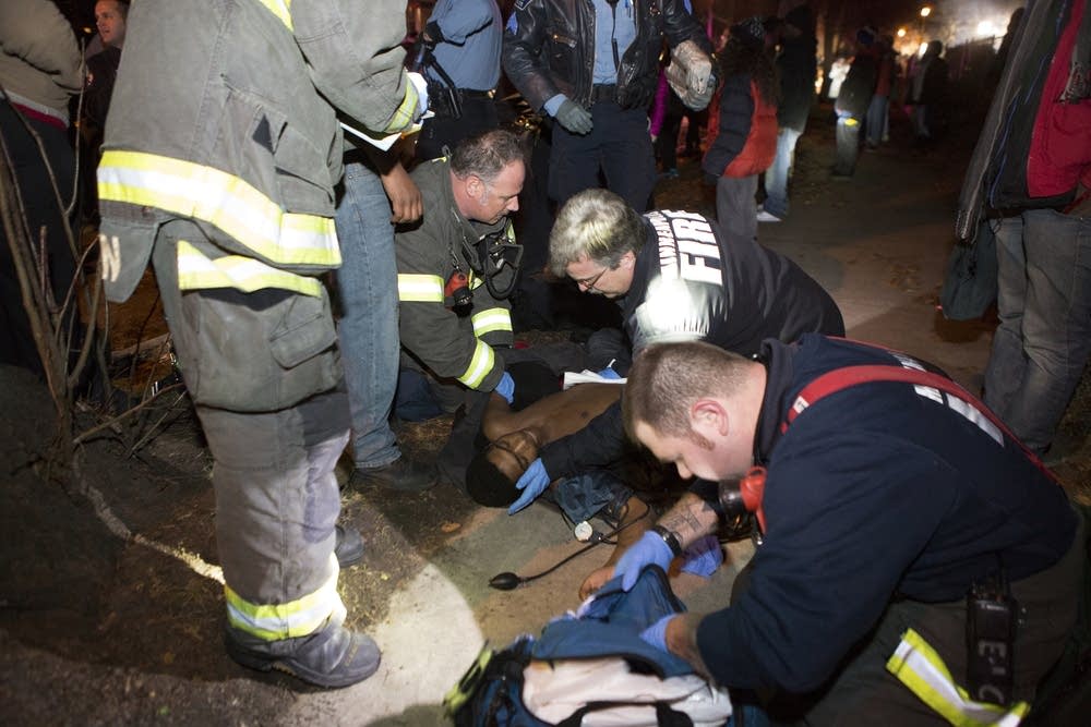 Paramedics tend to one of the shooting victims.
