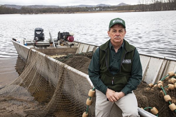 A man sits on a boat.