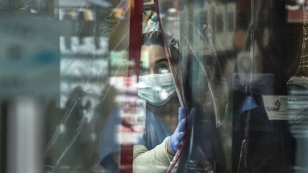 A pharmacist working in protective gear. A CDC report shows that mental health issues are plaguing many essential workers.
