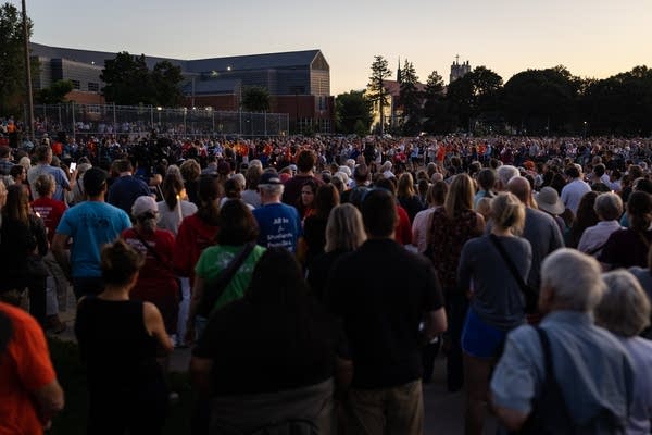 A crowd gathers at a park