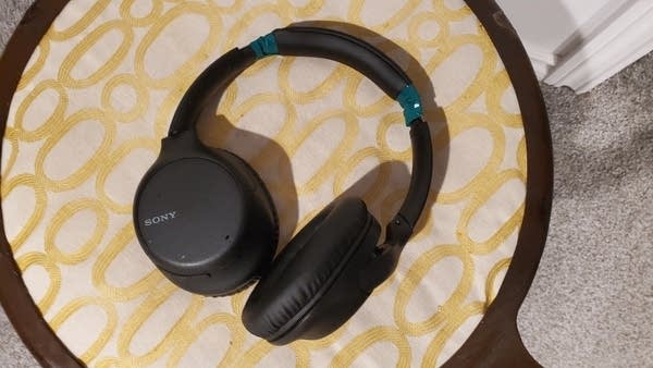 Wireless, over-the-ear headphones w/ green electrical tape on them
