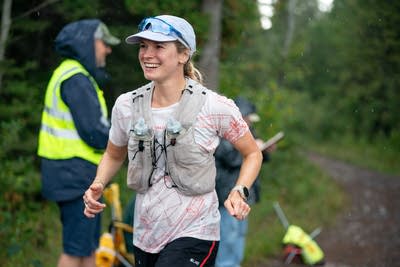 A woman runs with a vest