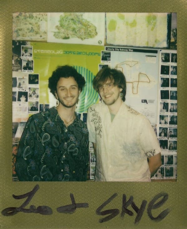 2 men posing for a polaroid photo in the carbon sound studio