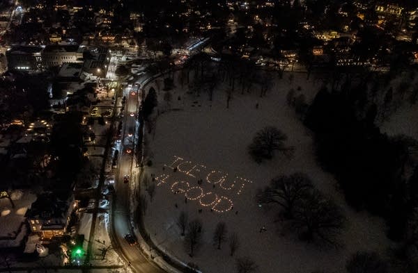 Aerial shot of a park, where "ICE OUT 4 GOOD" is spelled with luminaries.