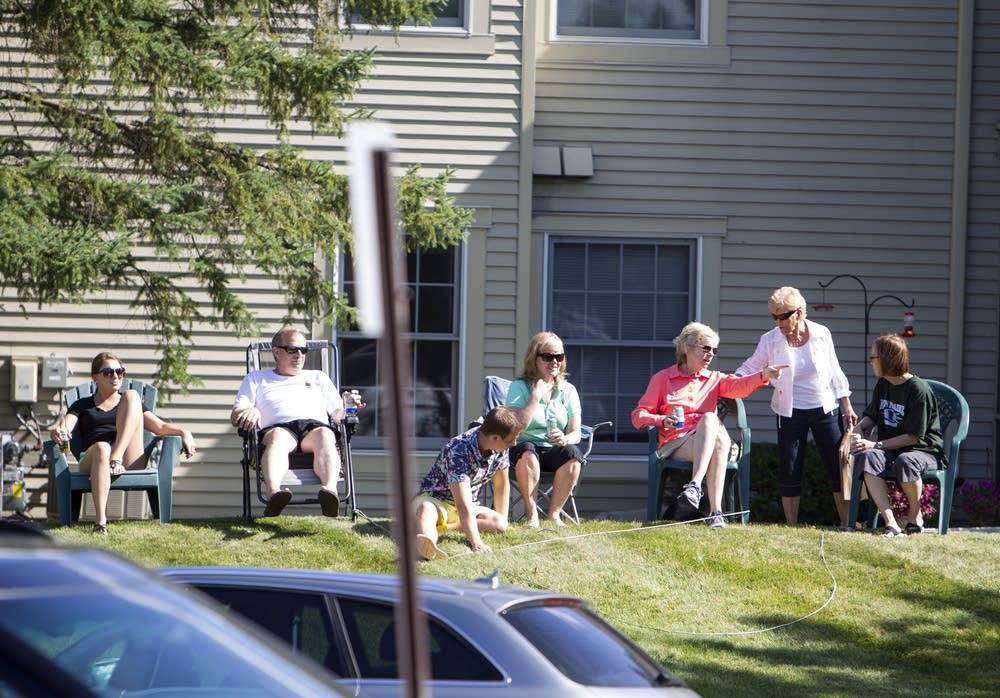 Neighbors set up chairs to watch the protest.