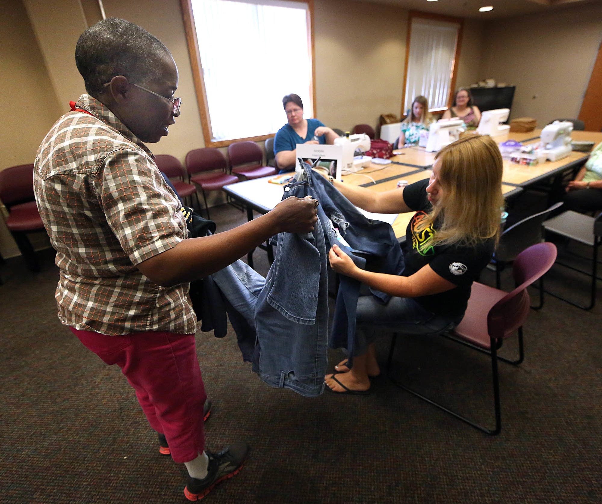 Lisa Frost (right) listens as Pam Bolling explains what repairs she needed.