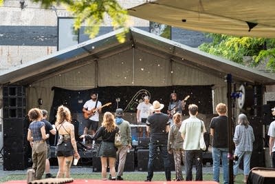 the band oeurth performing on stage outdoors