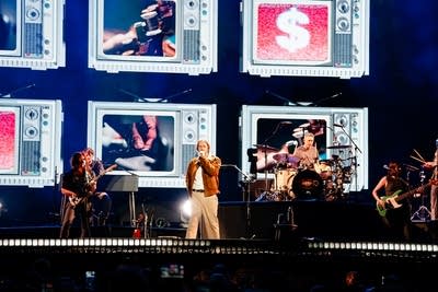 Hozier and band performing on stage