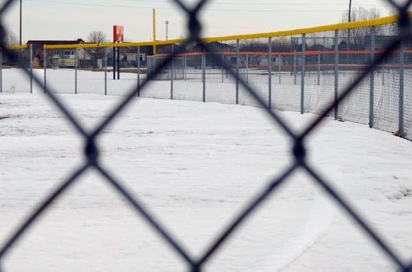 Snow covers the outfield of this diamond at Moorhead High School.