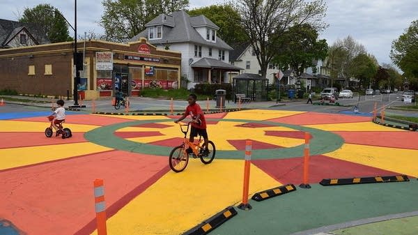 Children bike over painted crosswalk