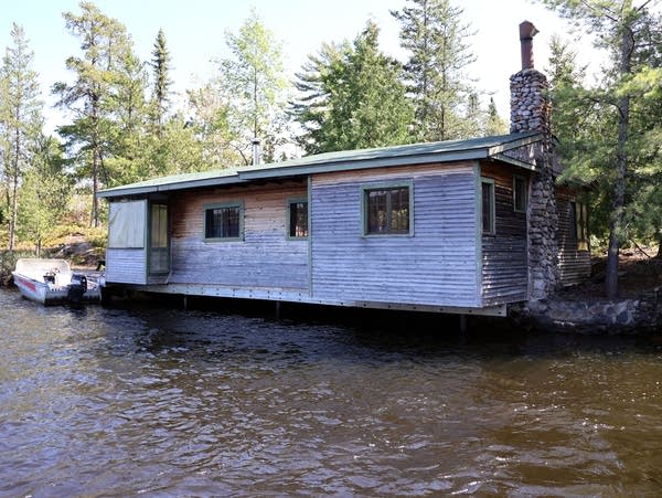 a grey building over water