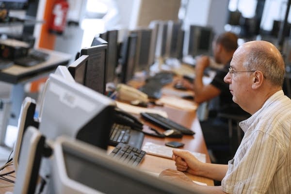 Employees work in a monitoring office at