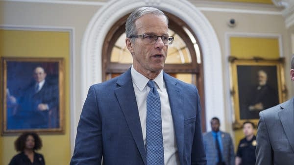 Senate Majority Leader John Thune, R-S.D., rushes from the chamber to his office at the Capitol in Washington.