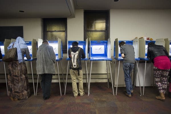 Voters fill out ballots.