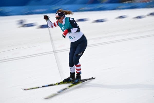 An athlete pushing forward on cross country skis.