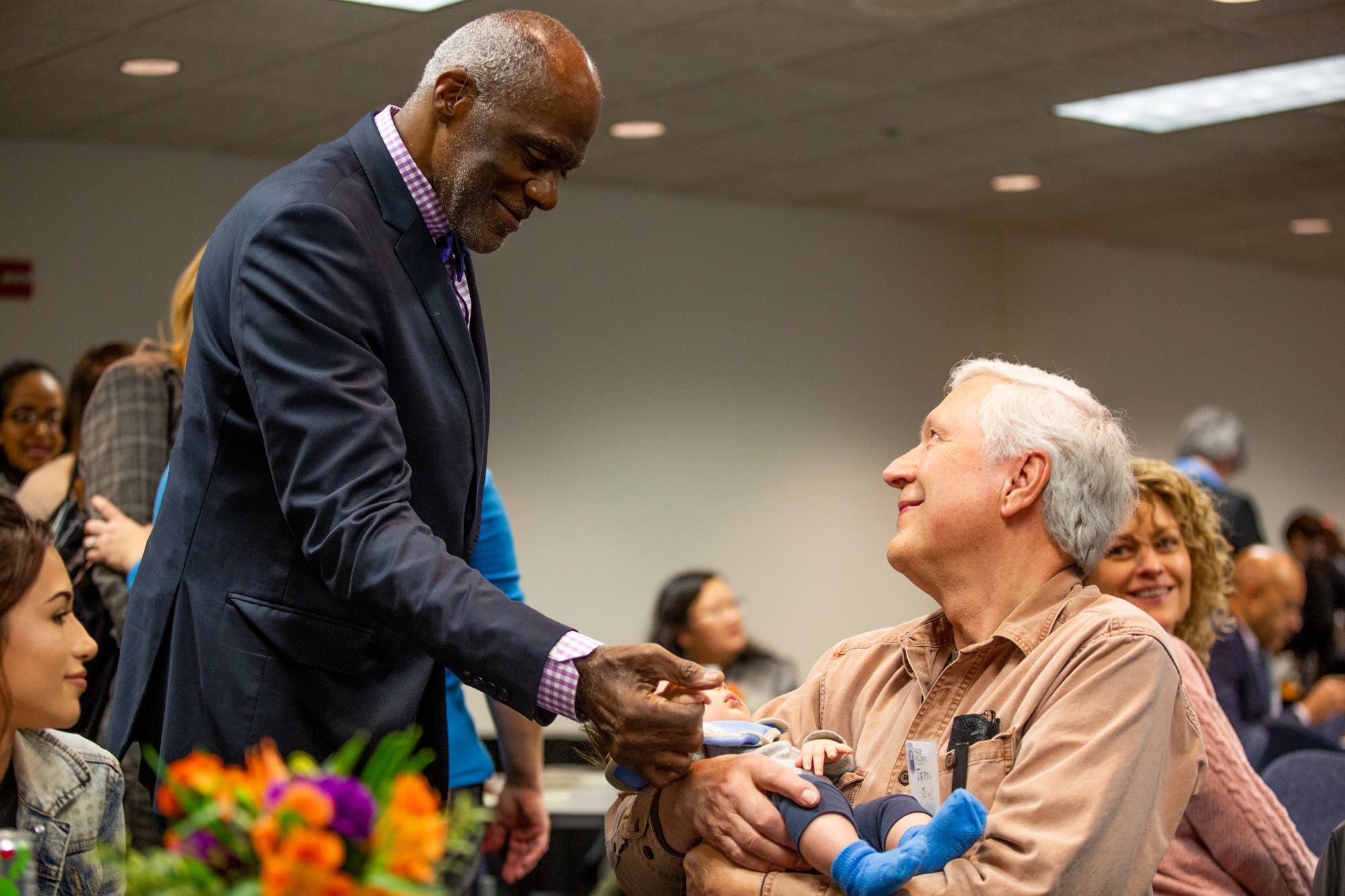 Retired Minn. Supreme Court Justice Alan Page greets his grand-nephew.